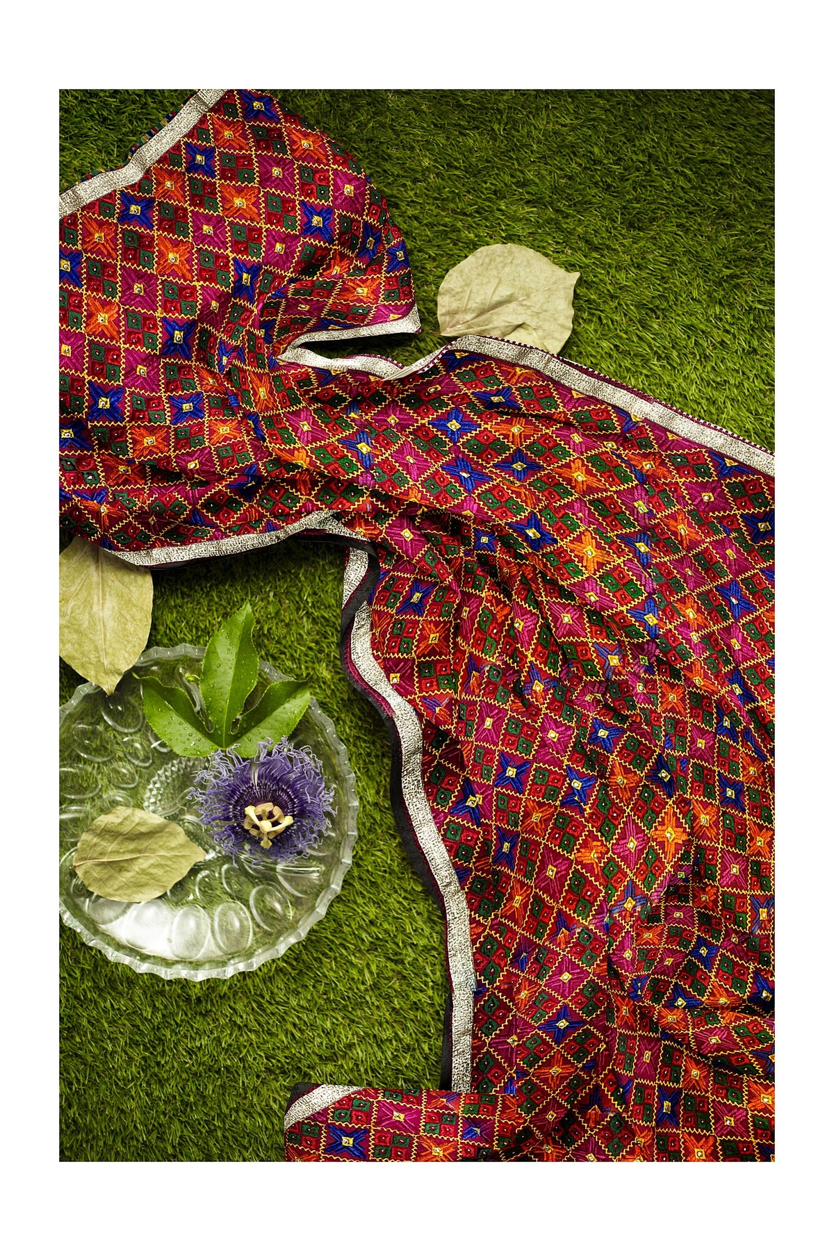 Rangoli Charm Phulkari reflects the vibrant magenta base and multicolor embroidery, reminiscent of a traditional rangoli design, full of color and cultural richness.