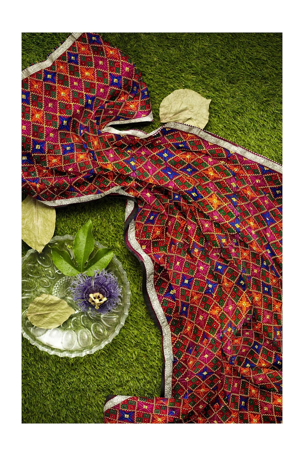 Rangoli Charm Phulkari reflects the vibrant magenta base and multicolor embroidery, reminiscent of a traditional rangoli design, full of color and cultural richness. - The Amritsar Store