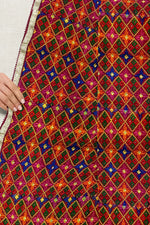 Rangoli Charm Phulkari reflects the vibrant magenta base and multicolor embroidery, reminiscent of a traditional rangoli design, full of color and cultural richness. - The Amritsar Store