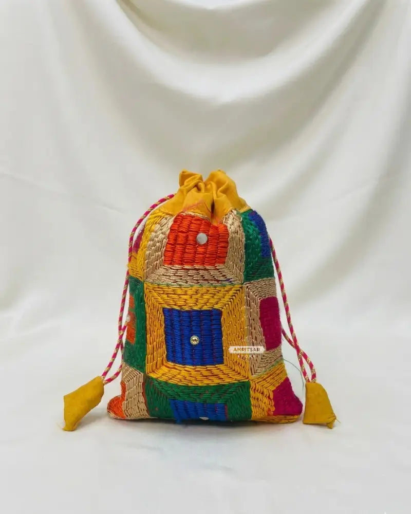 Traditional Punjabi multicolor Phulkari embroidered potli bag for women by The Amritsar Store.