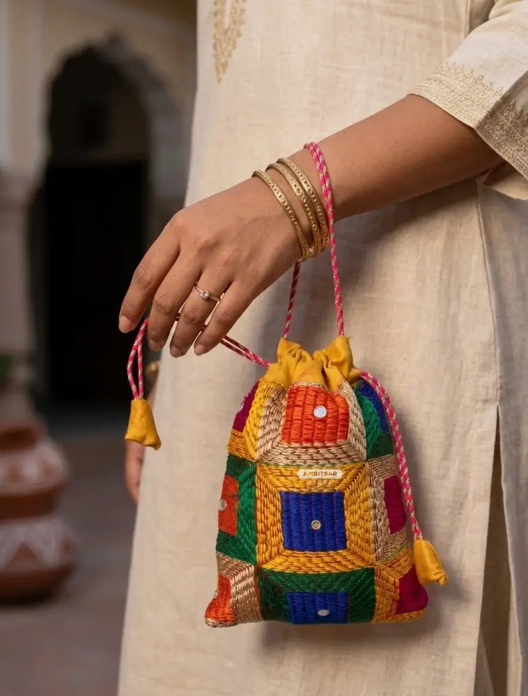 Traditional Punjabi multicolor Phulkari embroidered potli bag for women by The Amritsar Store.