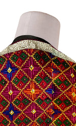Rangoli Charm Phulkari reflects the vibrant magenta base and multicolor embroidery, reminiscent of a traditional rangoli design, full of color and cultural richness.
