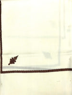 White fabric with brown embroidery on a white background
