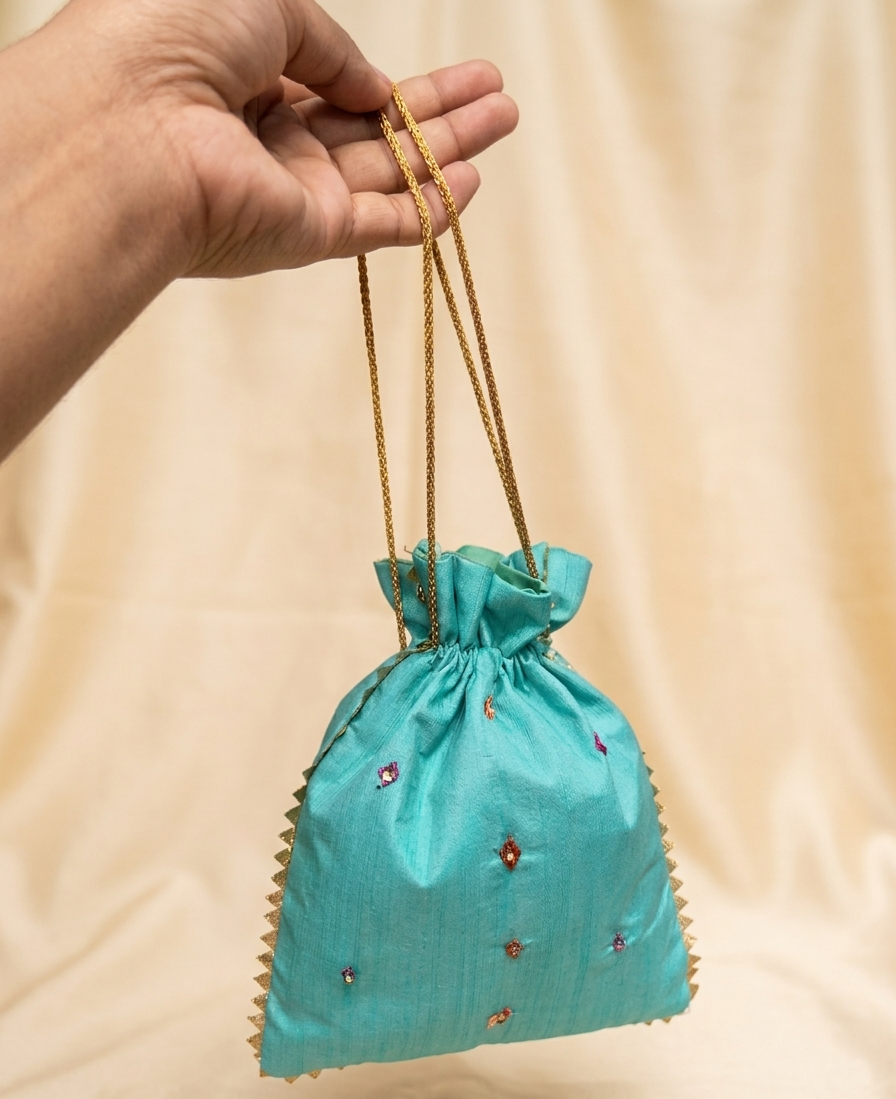 Handcrafted Phulkari Potli Bag by The Amritsar Store featuring vibrant Punjabi embroidery, perfect for weddings, festive occasions, and ethnic wear styling.