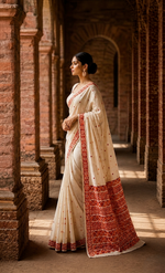 Hand embroidered off white Phulkari saree for women featuring traditional orange and maroon Punjabi embroidery motifs.