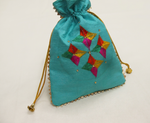 Handcrafted teal Phulkari embroidered potli bag with multicolor geometric floral design, golden lace border, and drawstring closure, traditional Punjabi ethnic accessory