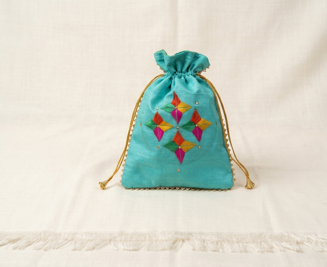 Handcrafted teal Phulkari embroidered potli bag with multicolor geometric floral design, golden lace border, and drawstring closure, traditional Punjabi ethnic accessory