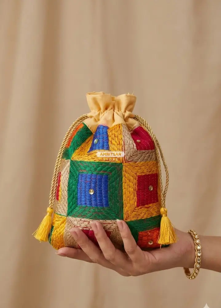 Traditional Punjabi multicolor Phulkari embroidered potli bag for women by The Amritsar Store.