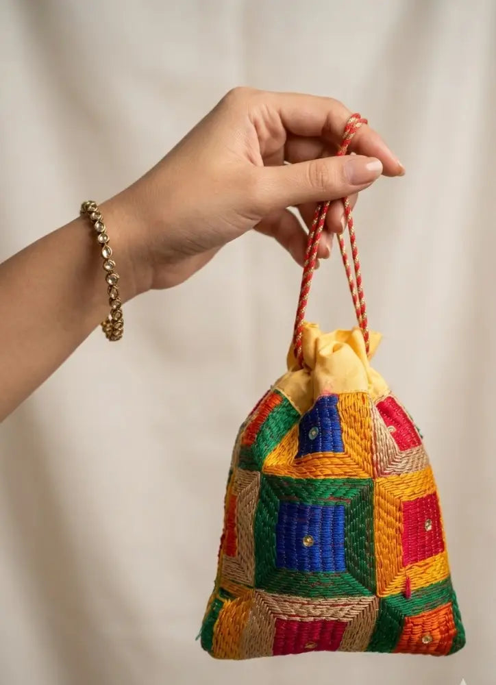 Traditional Punjabi multicolor Phulkari embroidered potli bag for women by The Amritsar Store.