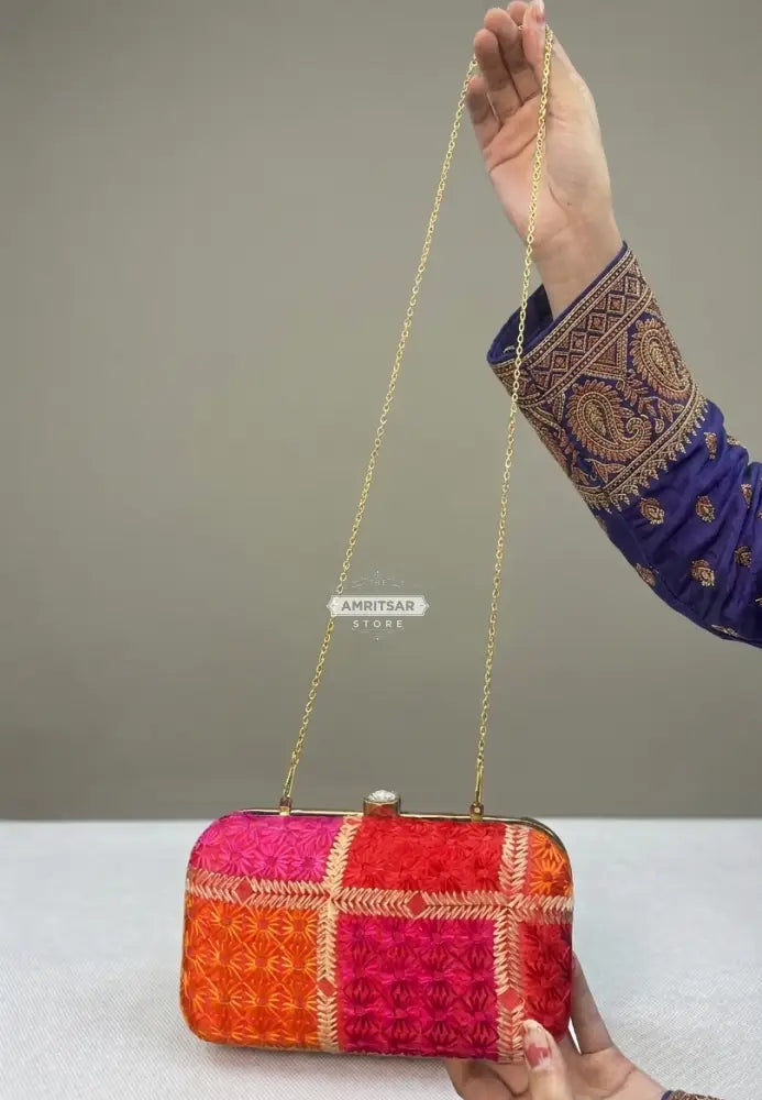 The Amritsar Store handmade red clutch bag with green floral embroidery, traditional ethnic handcrafted evening purse for women